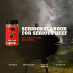 A jar of Fynn. 'Crazy Cow' beef rub shown next to a black smoking grill with bold white and red text reading 'SERIOUS FLAVOUR FOR SERIOUS BEEF' on a dark, smoky outdoor background.