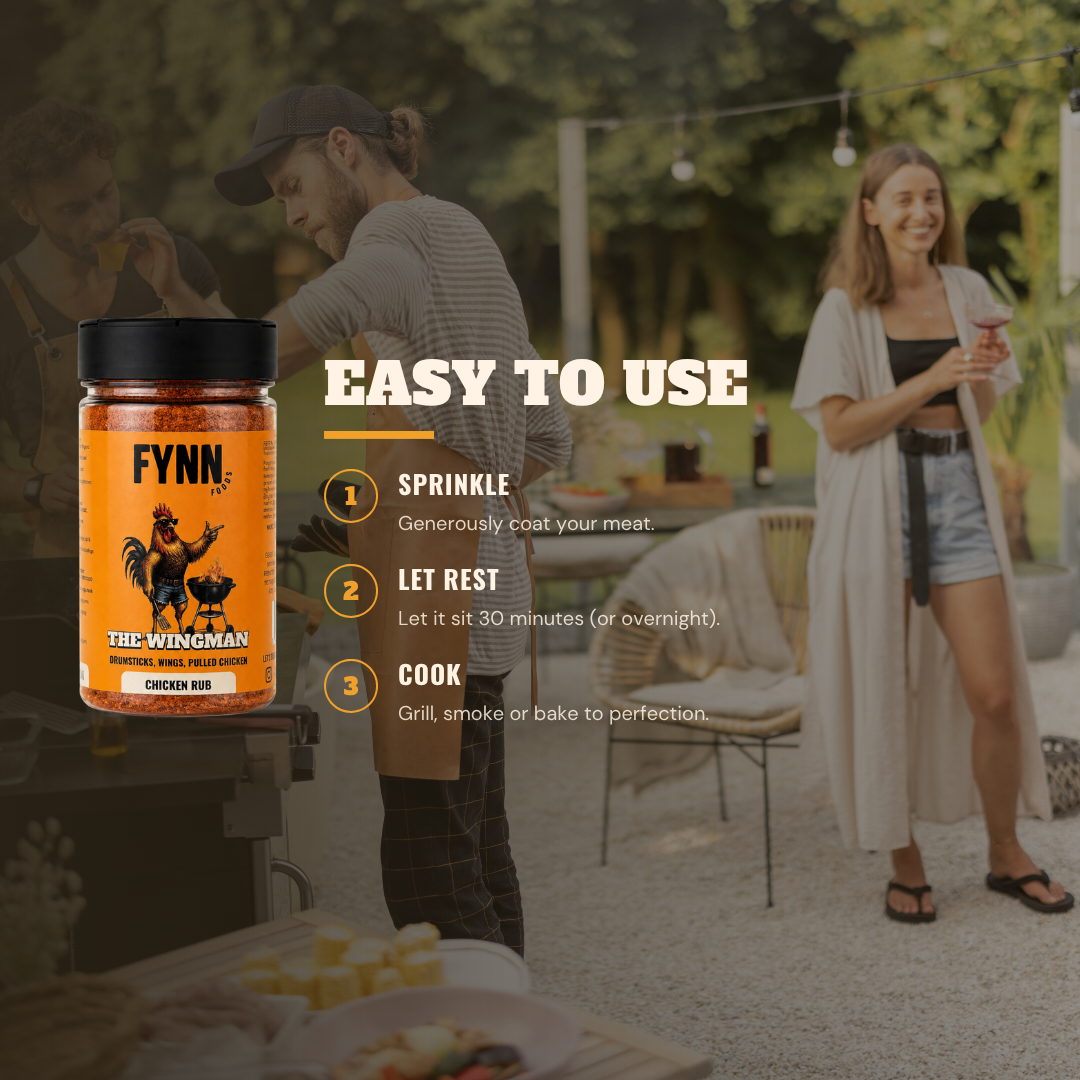 A jar of Fynn The Wingman Chicken Rub seasoning is shown in the foreground on the left, with a large 'EASY TO USE' instruction overlay on the right, set against a blurred outdoor patio background with people.